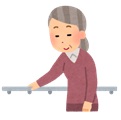 手すりにつかまりながら歩くおばあちゃん